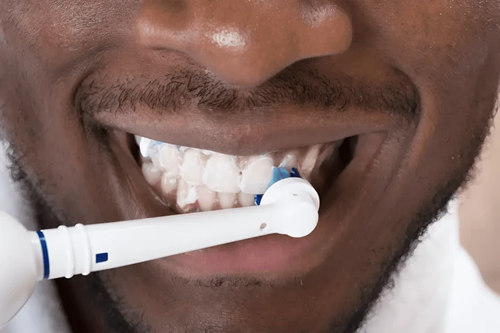 By using toothpaste with fluoride, one can lower their risk of developing dental cavities.